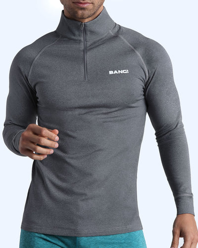 Frontal view of male model wearing the FIRM GREY in a solid grey quick-dry long-sleeve shirt by the Bang! brand of men's beachwear from Miami.