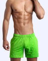 Frontal view of male model wearing the GREENDURANCE jogger shorts in a solid green quick-dry by the Bang! brand of men's beachwear from Miami.