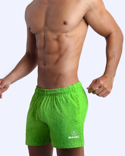 Frontal view of male model wearing the GREENDURANCE jogger shorts in a solid green quick-dry by the Bang! brand of men's beachwear from Miami.