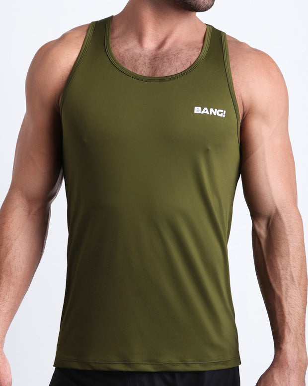 Frontal view of male model wearing the GREENSPIRATION in a solid green gym tank top for men by the Bang! brand of men&
