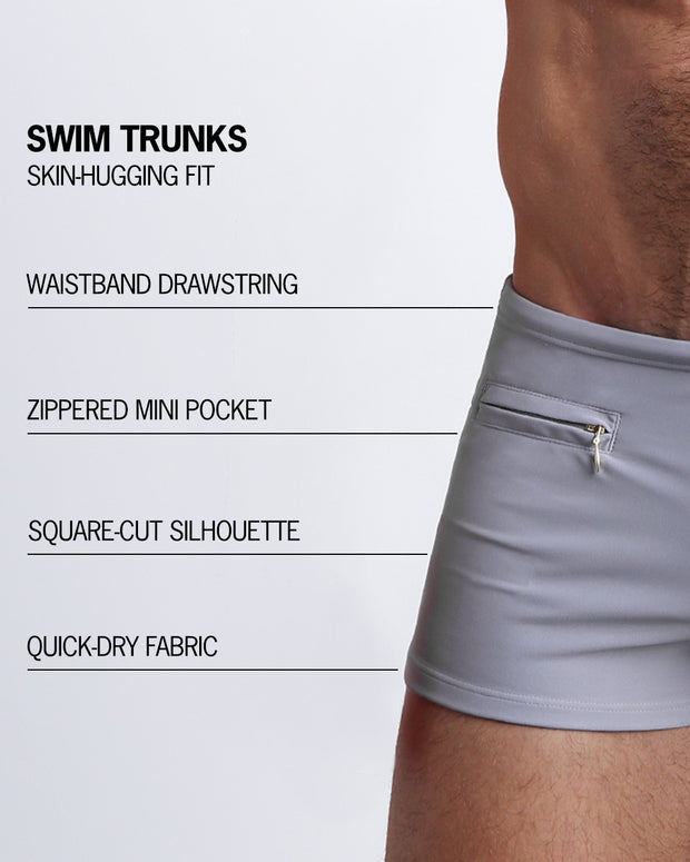 Infographic explaining the features of the GREY ANATOMY Swim Trunks by BANG! Clothes. These skin-hugging swimming shorts are quick-dry, have waistband drawstring, zippered mini pocket, have square-cut silhouette.