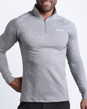 Frontal view of male model wearing the GREY ANATOMY in a solid gray quick-dry long-sleeve shirt by the Bang! brand of men's beachwear from Miami.