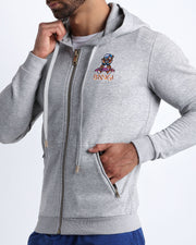 Side view of the GREY men's full-zip hooded fleece sweatshirt by BANG! Clothes based in Miami. This hoodie is soft and skin-friendly with two pockets to store small things and keep hands warm. 
