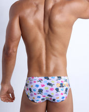 Back view of model wearing the HEY MISTER TJ (POOLSIDE MIX) Men’s beach briefs by BANG! with clubbing and disc-jockey details in dark colors.