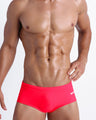 Frontal view of a sexy male model wearing men’s swimsuit in bright red by the Bang! Menswear brand from Miami.