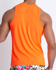 Back view of a male model wearing a men’s tank top in a beautiful orange color by the Bang! Clothes brand of men's beachwear from Miami.