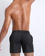 Backside view of men's gym jogger sweatshorts from Bang! Clothes brand with low-rise sit and shape-enhancing cuts.