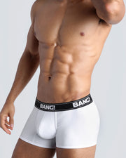 Side view of a sexy male model wearing a BANG! Cotton Boxer Briefs for men in a white color. Offers stay-put leg design that prevents chafing and riding up the leg. 