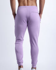 Back view of men's high quality outdoor track pants in a solid light lilac color with back zippered pocket. Suitable for daily, running, working out, exercise and hanging out in Winter.