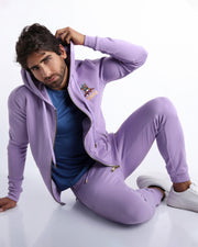 Sexy male model wearing the perfect light purple color men's sweatpants with zipper pockets to keep you warm during chilly fall weather. With it's soft, warm fabric and it's adjustable drawstring closure for custom fit.