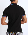 Side view of a male model wearing a slim fit sexy collared shirt for men from BANG! Miami in dark black color. 