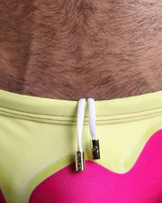 Close-up view of the MY MILKSHAKE men’s drawstring briefs showing white cord with custom branded golden cord ends, and matching custom eyelet trims in gold.
