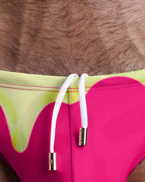 Close-up view of the MY MILKSHAKE men’s summer shorts by BANG! clothing brand, showing white cord with custom branded golden cord ends, and matching custom eyelet trims in gold.
