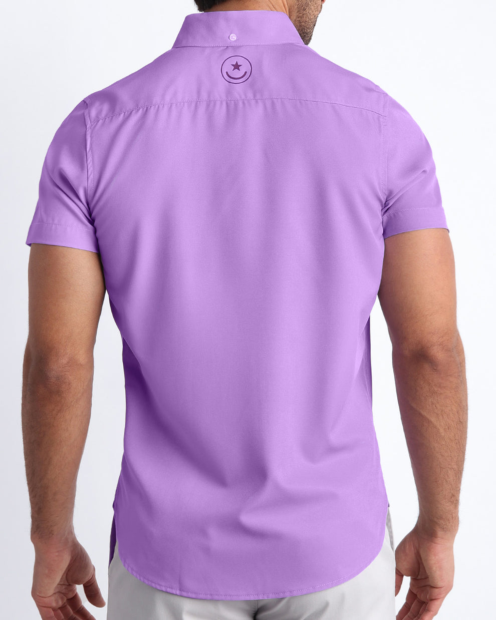 Back view of a male model wearing NEO VIOLET men’s Hawaiian shirt in a lilac purple color by the Bang! Clothes brand of men's beachwear.