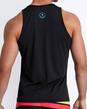 Back view of a male model wearing a men’s tank top in a bold black  color by the Bang! Clothes brand of men's beachwear from Miami.