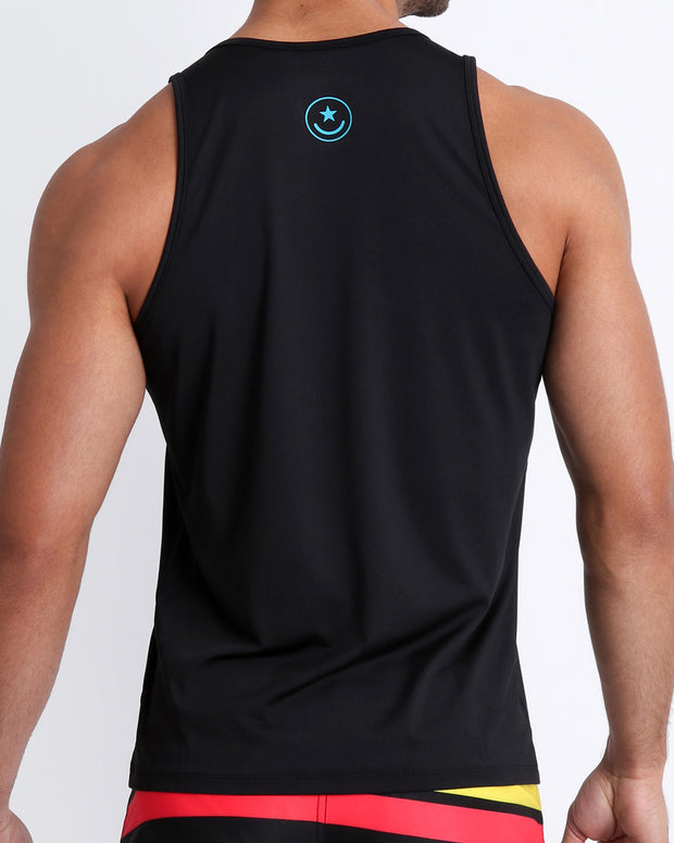 Back view of a male model wearing a men’s tank top in a bold black  color by the Bang! Clothes brand of men&