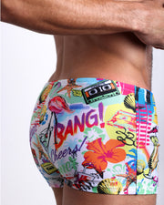 Side view of a masculine model wearing the PEOPLE FROM IBIZA compression swimwear shorts in a multi-color Miami inspired theme perfect for music festival like EDM by BANG! Clothes.
