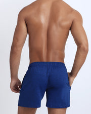 Back view of the PHYSICAL BLUE men's fitness sweatshorts in a navy color by BANG! menswear Miami.