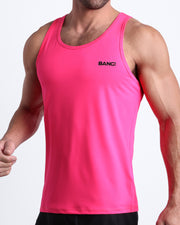 Side view of men’s workout tank top in solid pink color made by BANG! Clothing the official brand of mens beachwear. 