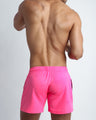 Back view of the PINKTENSITY men's fitness sweatshorts in a hot pink color by BANG! menswear Miami.