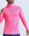 Frontal view of male model wearing the PINKTENSITY in a solid fluorescent pink quick-dry long-sleeve shirt by the Bang! brand of men's beachwear from Miami.