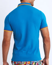 Back view of a sexy model wearing a short-sleeve classic polo shirt for men in a blue color from BANG! Clothing the official brand for menswear.