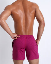 Back view of the POWERBERRY men's fitness sweatshorts in a berry pink color by BANG! menswear Miami.