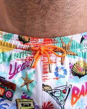 Close-up view of the PEOPLE FROM IBIZA men’s summer shorts, showing orange cord with custom branded golden cord ends, and matching custom eyelet trims in gold.