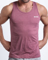 Frontal view of male model wearing the RIPPED CRIMSON in a heathered red gym tank top for men by the Bang! brand of men's beachwear from Miami.