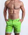 Front view of a male model wearing men's chino shorts in SPLENDID GREEN a light lime green color by BANG! Miami Clothes brand. 