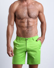 Front view of a male model wearing men's chino shorts in SPLENDID GREEN a light lime green color by BANG! Miami Clothes brand. 