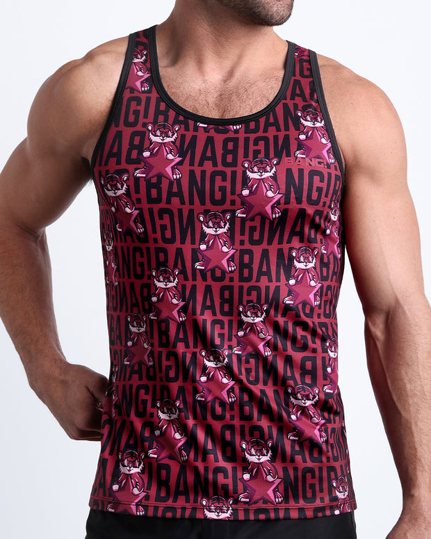 Front view of model wearing the STARSTRUCK men’s beach tank top in a red berry color with black BANG! Typography print and tiger pop art by the Bang! Clothes brand of men&