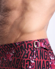 Close-up view of the STARSTRUCK men’s swimwear, showing custom branded golden adjustable side buckles.