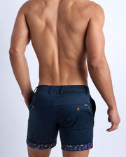 Back view of a model wearing woven twill cotton chino shorts in navy color for men by BANG! Clothing brand of Miami