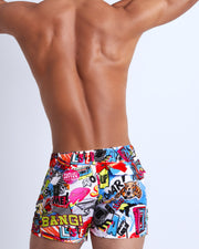 Back view of a sexy male model wearing Super Pop men's swimwear with pop-culture theme made by the Bang! brand of men's beachwear.