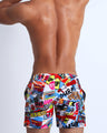 Back view of a sexy male model wearing a BANG Miami resort short with perfect fit designer quality colors and bold prints 2021