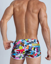 Back view of a sexy male model wearing men's swimwear with pop-culture theme made by the Bang! brand of men's beachwear.