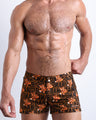 Front view of model wearing the TIGER HEARTS men’swim bottoms featuring Brown with Orange Tigers pop art by the Bang! Clothes brand of men's beachwear from Miami.