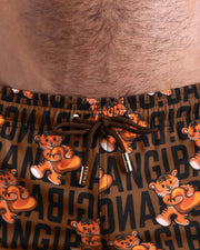 Close-up view of the TIGER HEARTS men’s summer shorts, showing black cord with custom branded golden cord ends, and matching custom eyelet trims in gold.