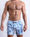 Frontal view of male model wearing the TOILE DE MIAMI (BLUE) men's premium quality swimwear bottoms by the Bang! Clothes brand of men's swimwear from Miami.