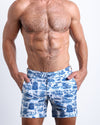 Front view of model wearing the TOILE DE MIAMI (BLUE) men’s beach tailored shorts with Toile De Jouy in White with Blue Art by the Bang! Clothes brand of men's beachwear from Miami.