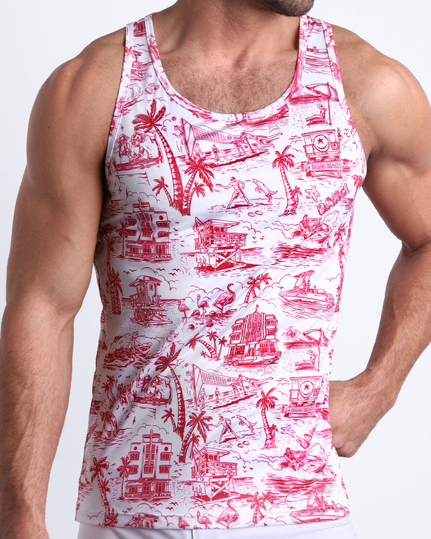 Front view of model wearing the TOILE DE MIAMI (RED) men’s beach tank top in white with red Toile De Jouy art by the Bang! Clothes brand of men&