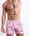 Front view of model wearing the TOILE DE MIAMI (RED) men’s beach tailored shorts with Toile De Jouy in White with Red Art by the Bang! Clothes brand of men's beachwear from Miami.