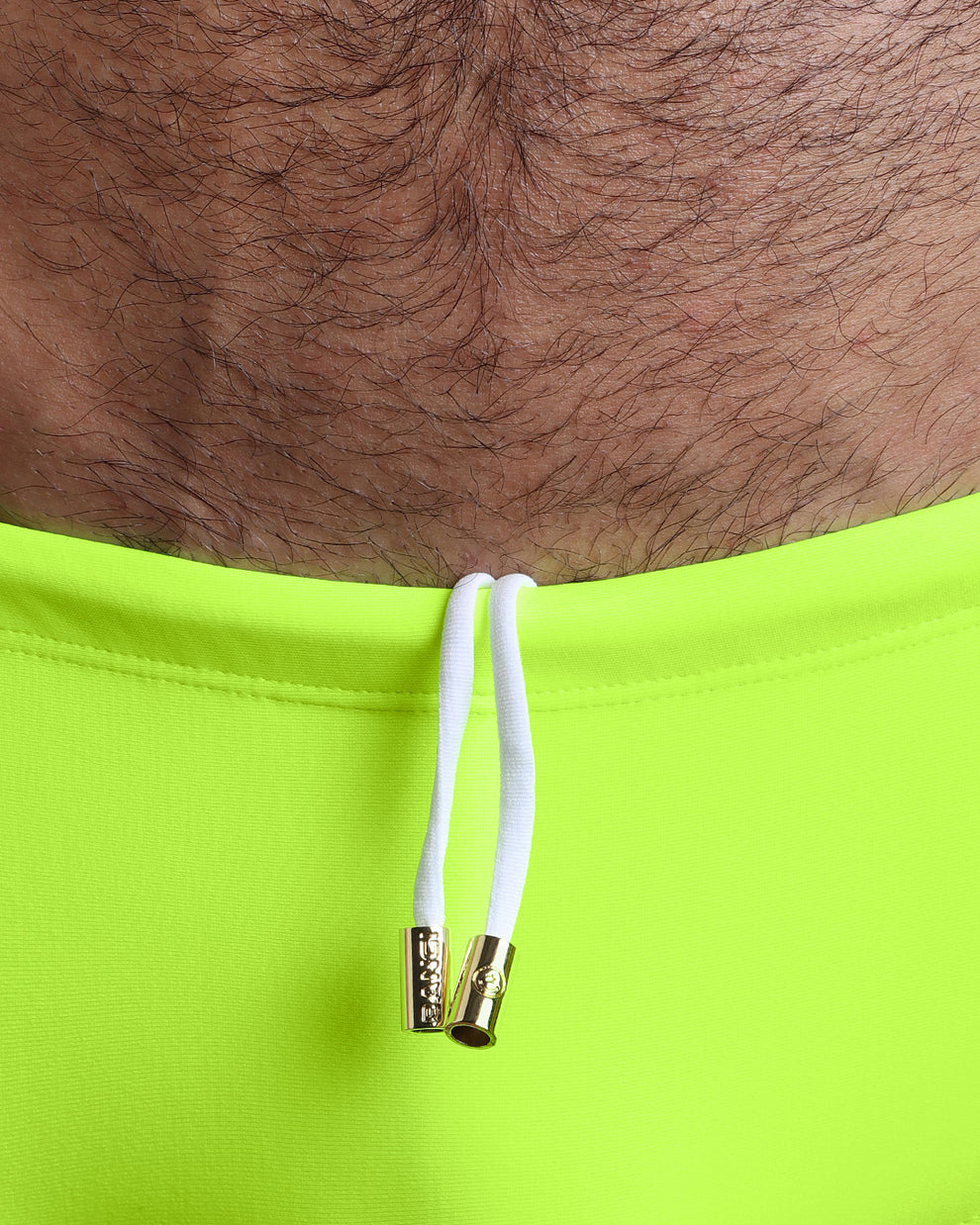 Close-up view of the ULTRA NEON Swim Sunga mens swimsuit a bright neon green color with white internal drawstring cord showing custom branded golden buttons by BANG! clothing brand.