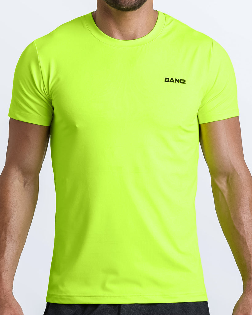 Frontal view of male model wearing the ULTRA NEON in a solid bright lime green quick-dry workout shirt by the Bang! brand of men's beachwear from Miami.