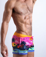 Side view of men’s shorter leg length shorts in a pop color with the miami sunset skyline made by Miami based Bang brand of men's beachwear.