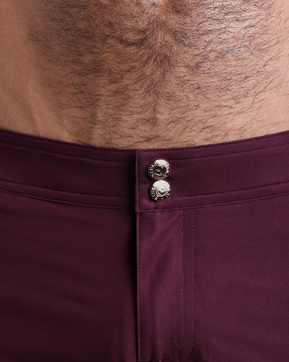 Close-up view of men’s summer beach shorts by BANG! clothing brand, showing custom branded golden buttons.