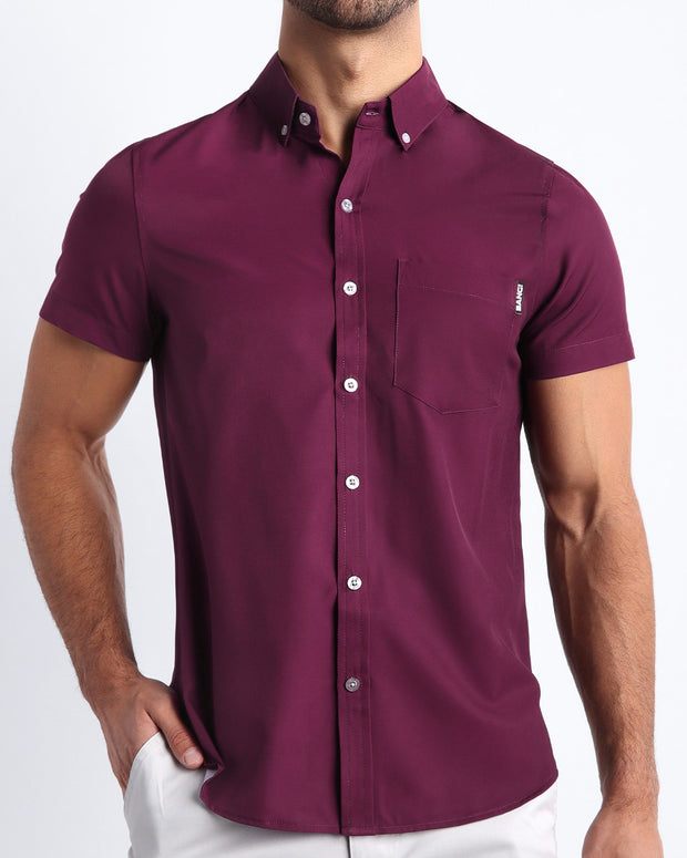 Front view of a sexy male model wearing VERY BERRY mens short-sleeve stretch shirt in a burgundy dark red color by the Bang! brand of men&