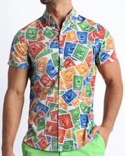 Front view of the VIA POSTAL men’s  short-sleeve hawaiian stretch shirt in white with colorful Miami pop art postage stamps designed by the Bang! brand of men's beachwear from Miami.