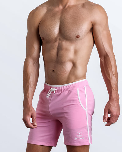 Side view of men’s calisthenics exercise shorts for men in a bubblegum pink color made by BANG! Clothing the official brand of mens sportswear.
